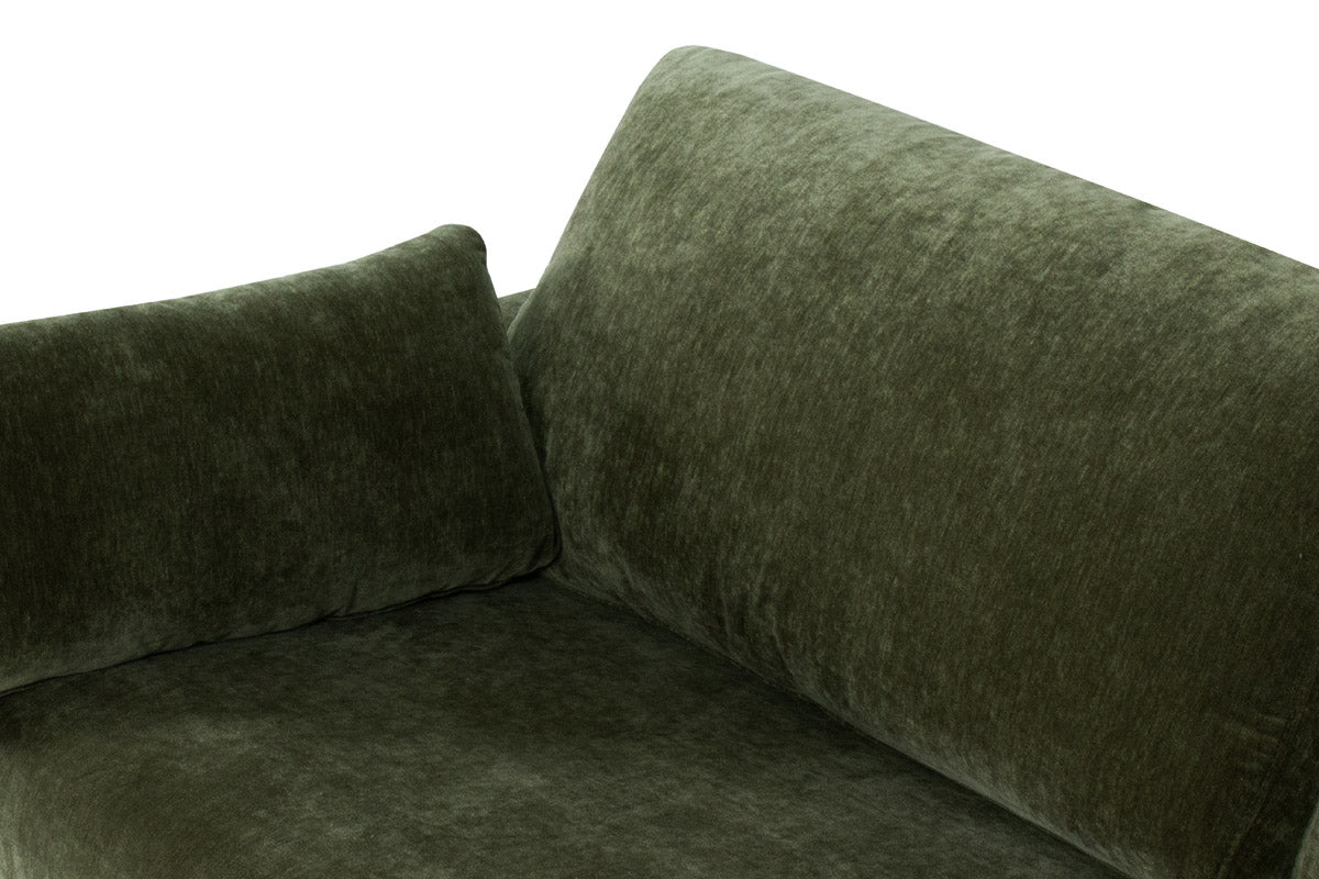Green velvet corner sofa on a white background