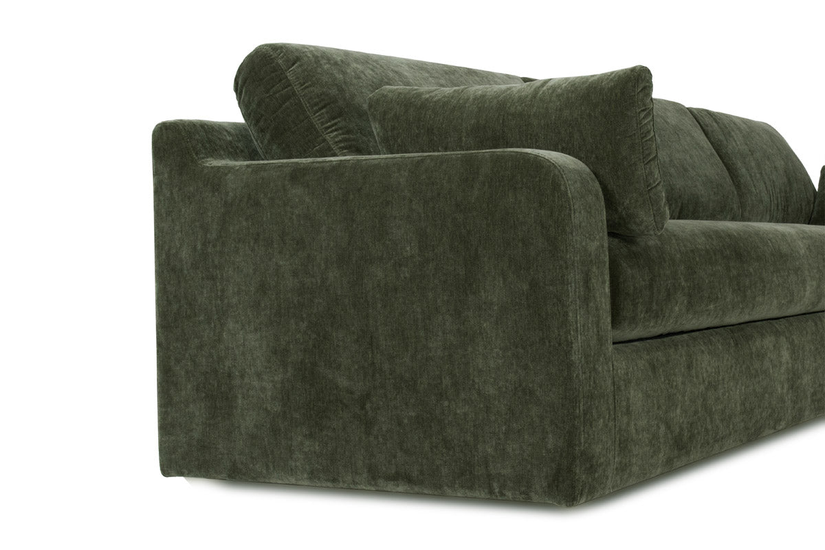 Green velvet sofa on a white background