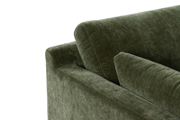 Green velvet sofa on a white background