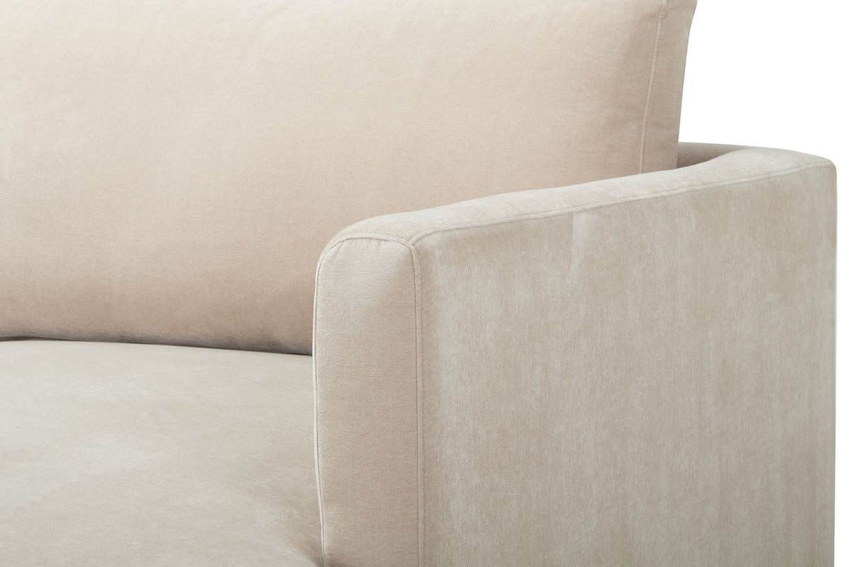 Close-up of a beige sofa with a soft texture on a white background