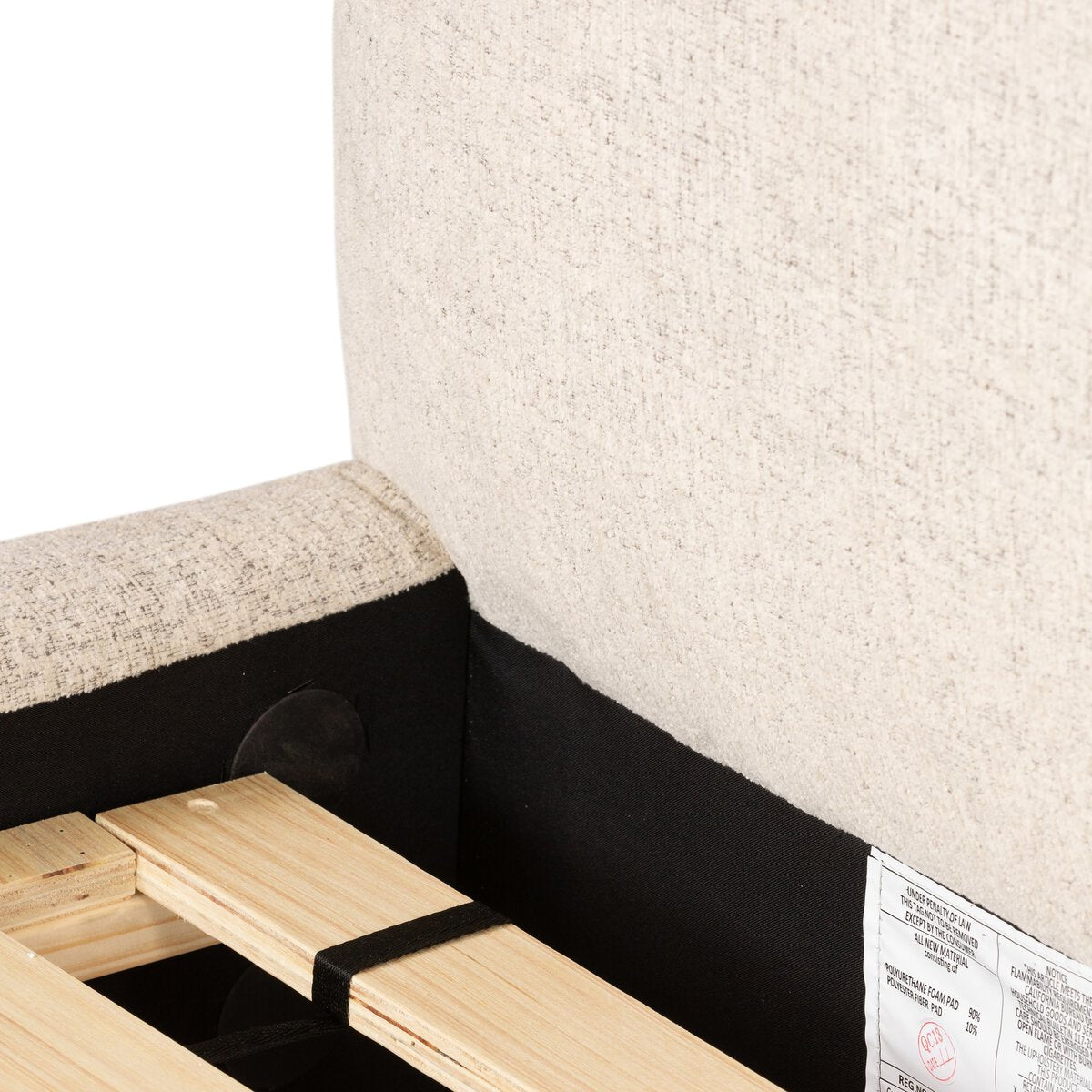 Wooden bed frame with mattress corner and visible brand label.