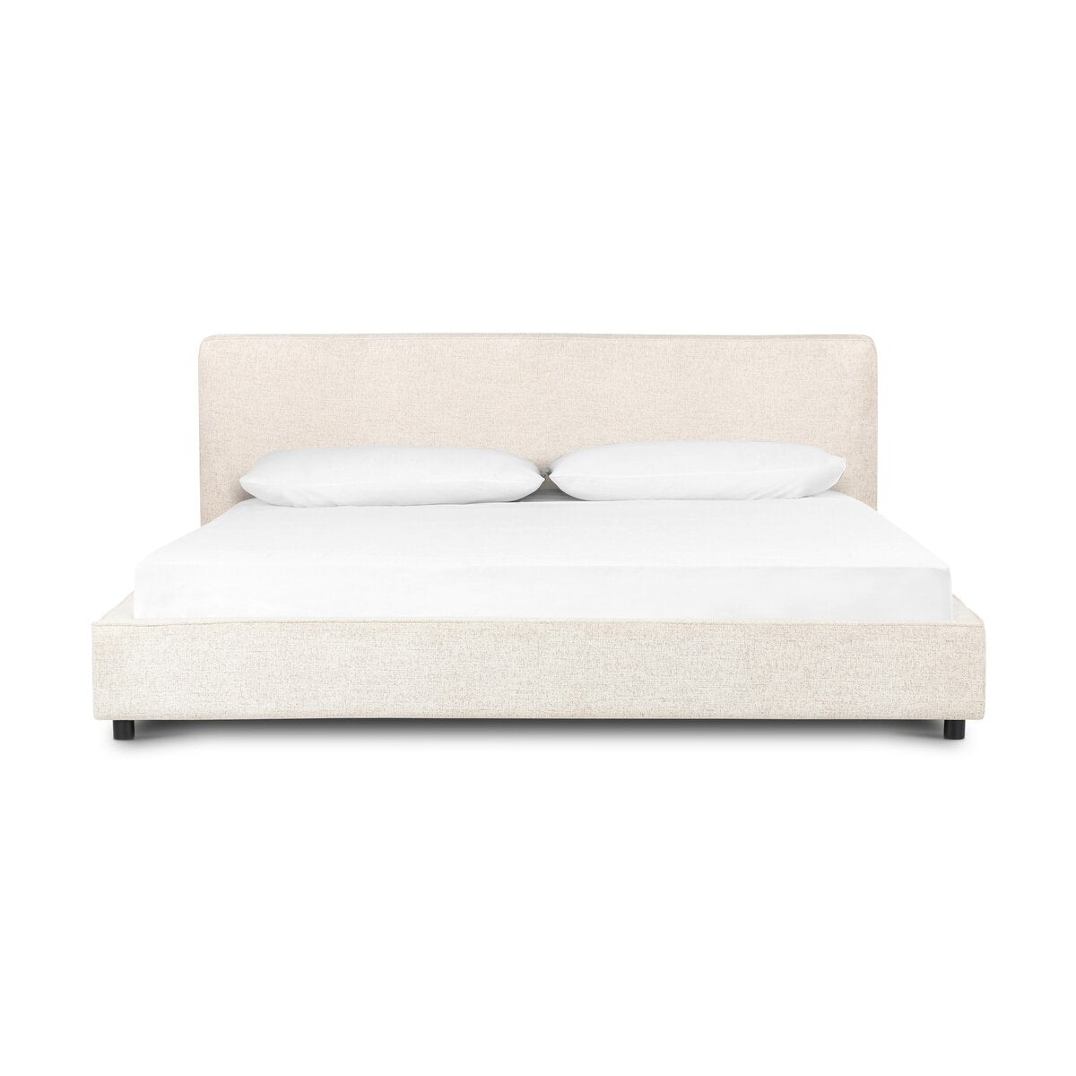 Beige upholstered bed with white bedding on a white background