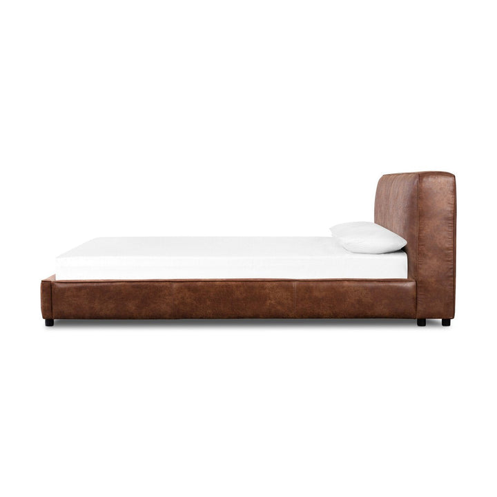 Brown leather bed with white mattress and pillow on a white background