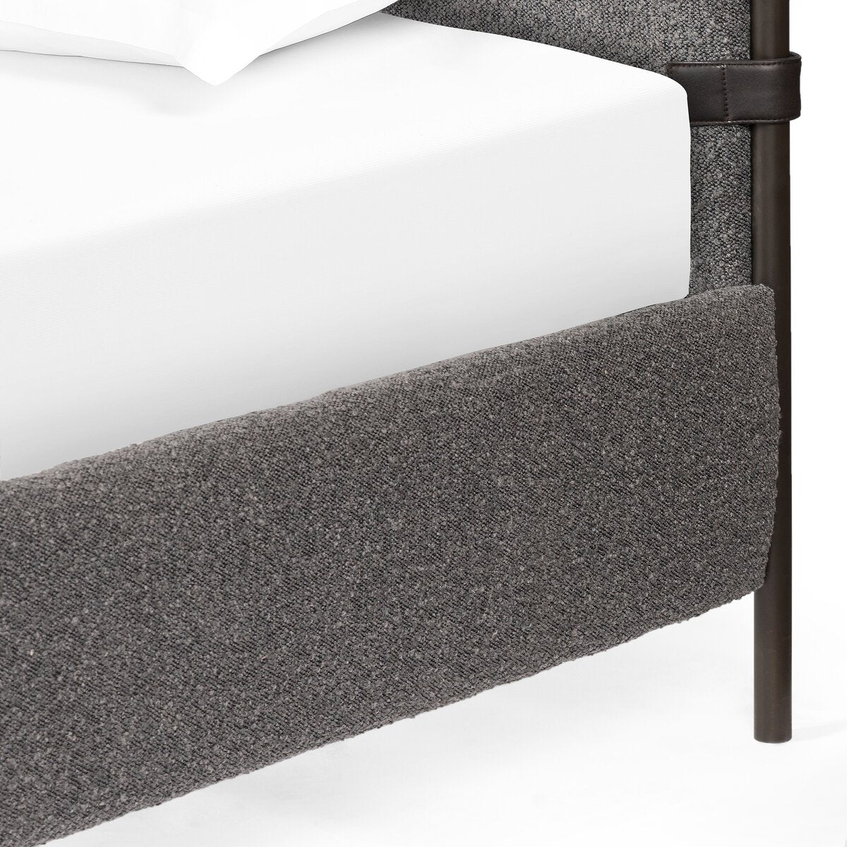 Gray upholstered bed frame with white mattress on a white background