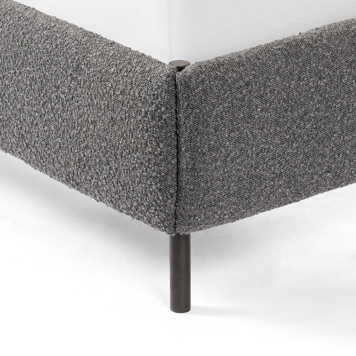 Gray upholstered corner piece on a white background