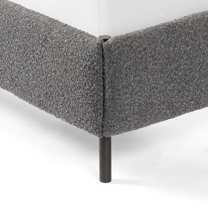 Gray upholstered corner piece on a white background