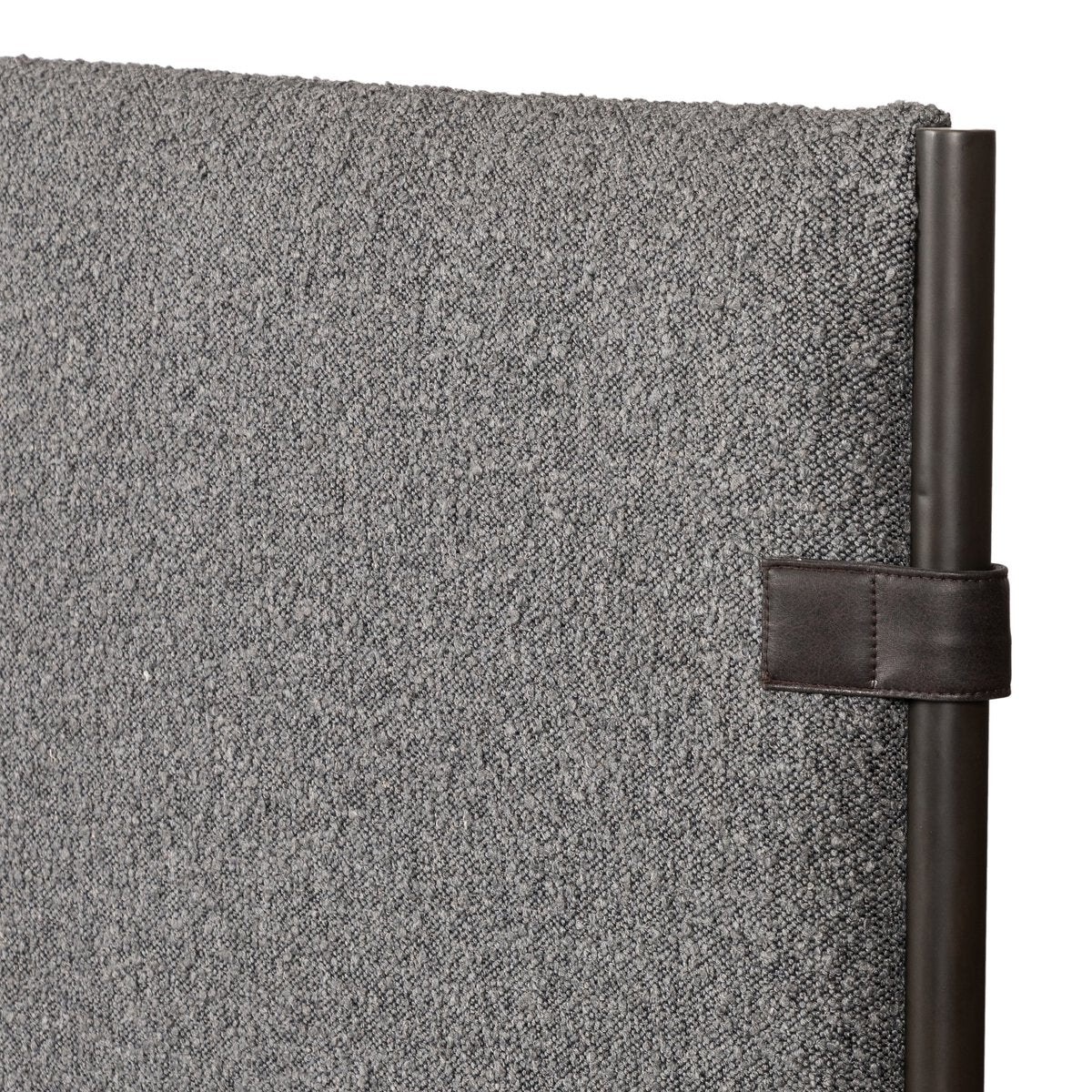 Gray textured wall with a black strap attached
