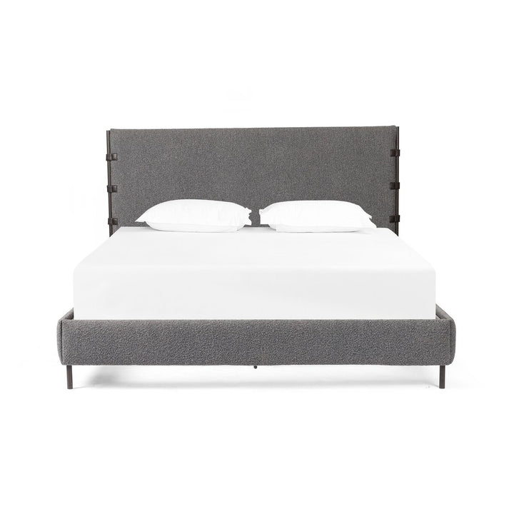 Gray upholstered bed with white mattress and pillows on a white background