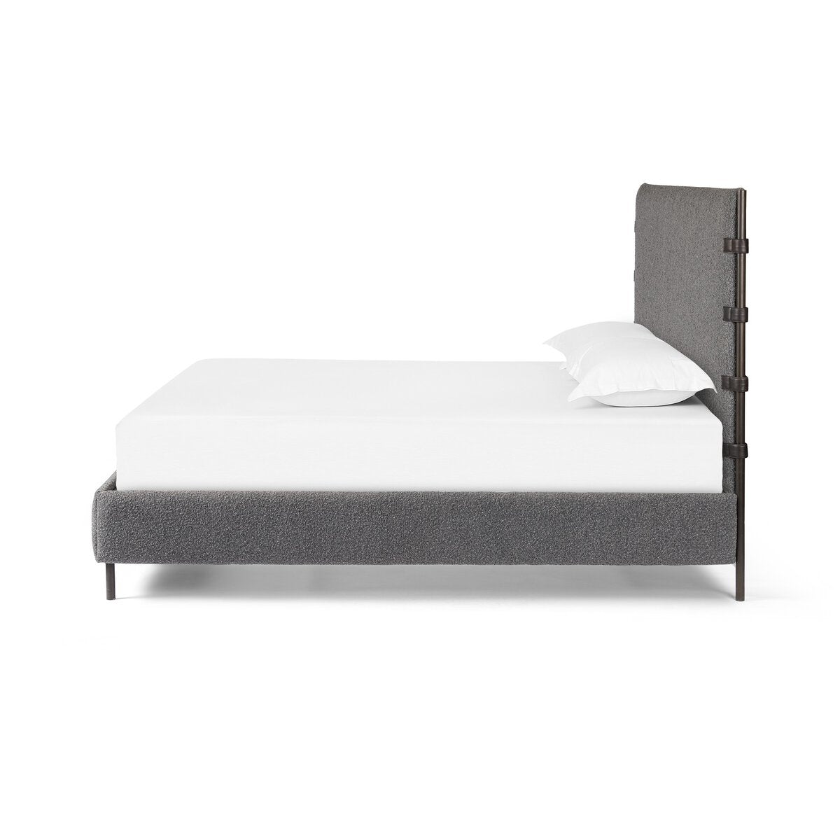 Gray upholstered bed with white mattress and pillow on a white background