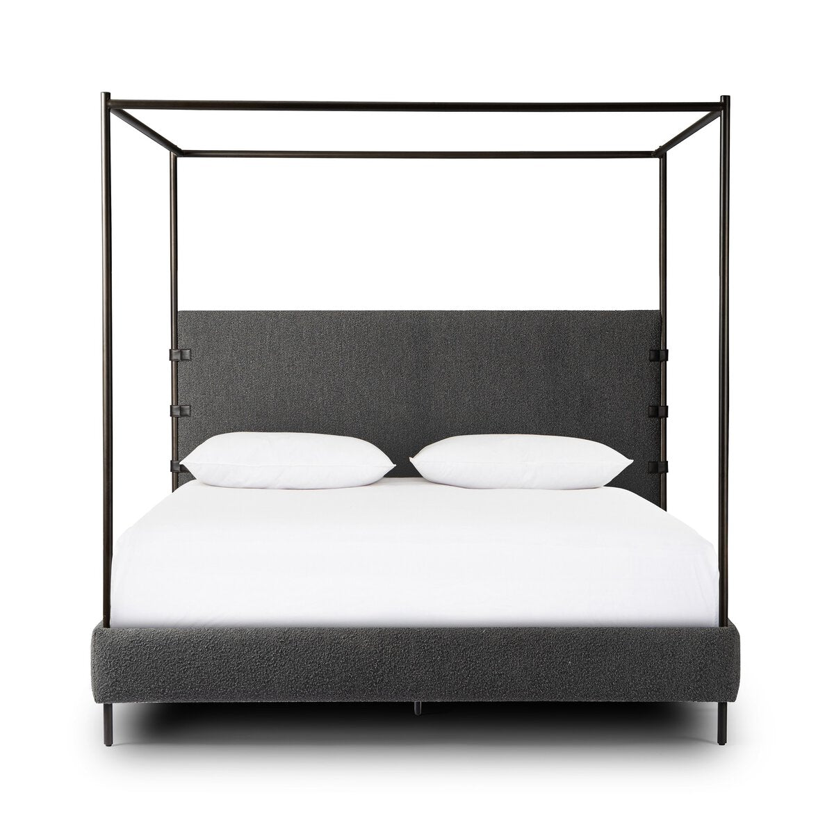 Four-poster bed with black metal frame and gray upholstered headboard on a white background