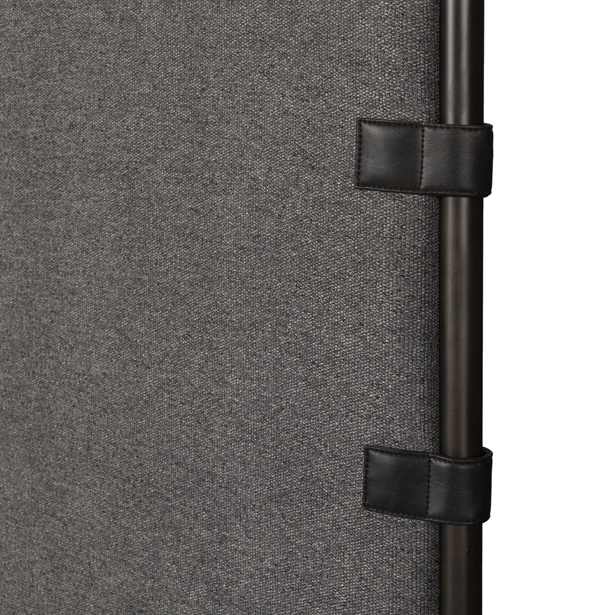 Close-up of a textured gray surface with black straps and buckles.