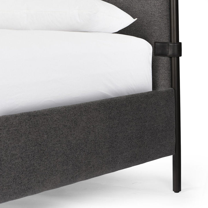 Gray upholstered bed frame with black metal legs on a white background