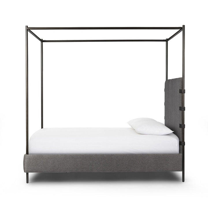Four-poster bed with gray upholstered headboard and footboard on a white background
