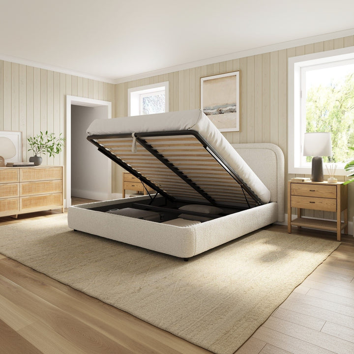 White bed with raised headboard in a bright bedroom