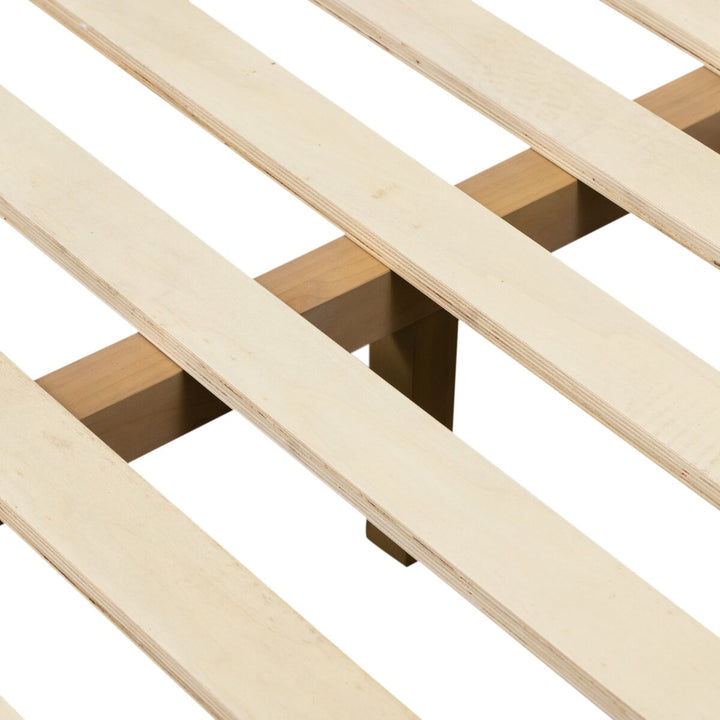 Close-up of a wooden slatted bed frame on a white background