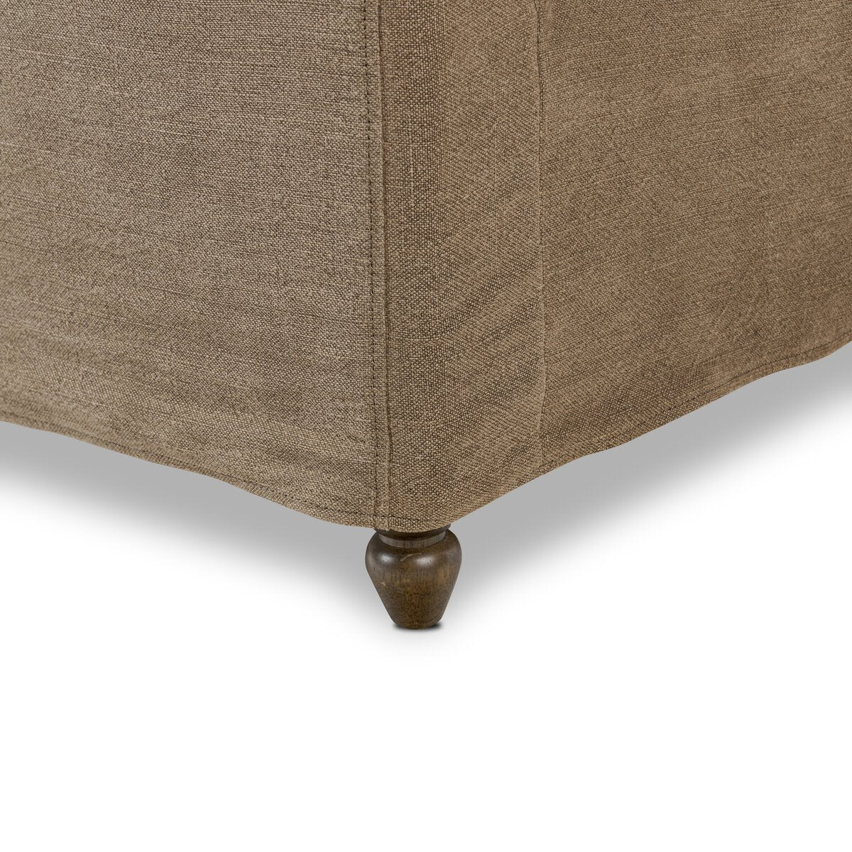 Close-up of a brown upholstered chair with a wooden leg on a white background