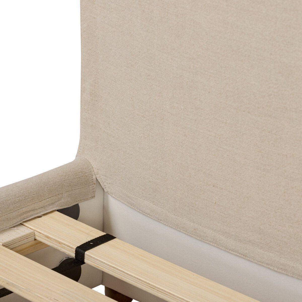 Close-up of a beige upholstered chair with wooden legs on a white background