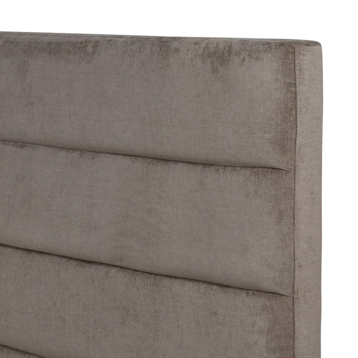 Gray upholstered headboard with a smooth texture on a white background