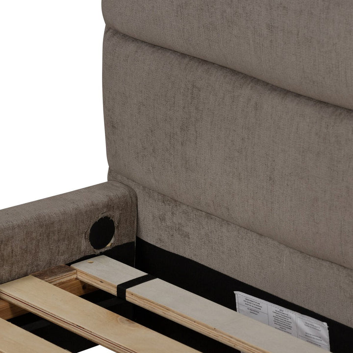 Brown upholstered chair with wooden seat and black frame on a white background