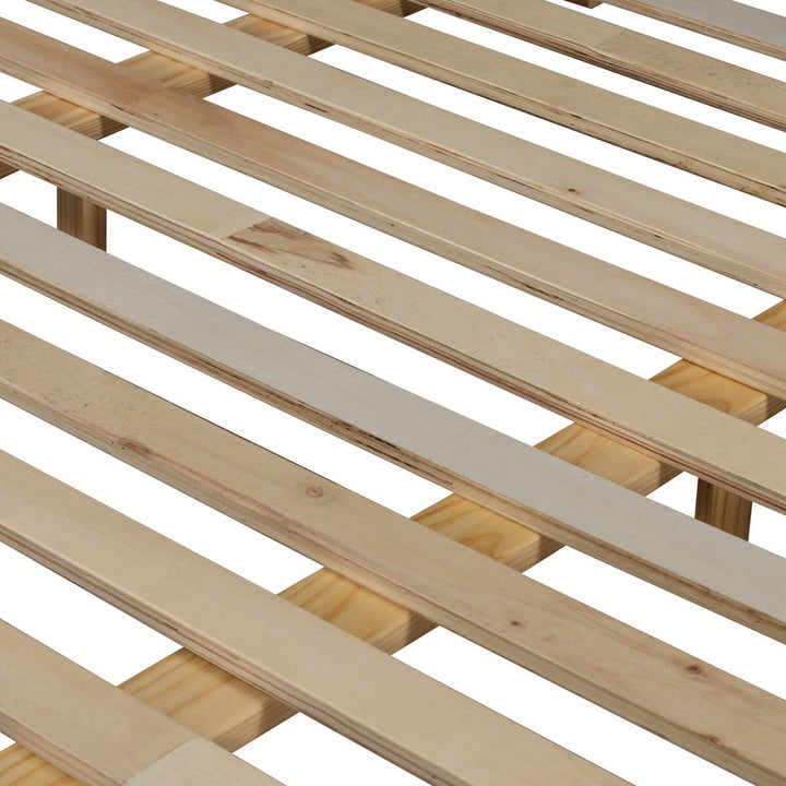 Close-up of a wooden slatted bed frame on a white background