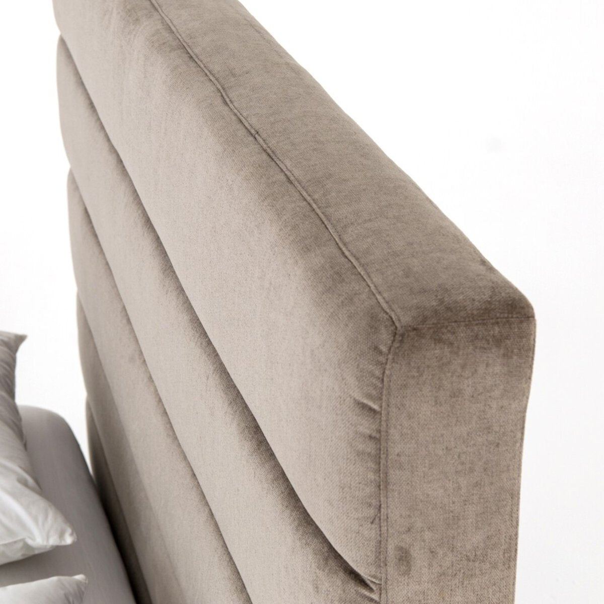 Close-up of a beige upholstered chair with a white background