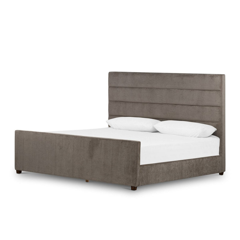 Gray upholstered bed with white bedding on a white background