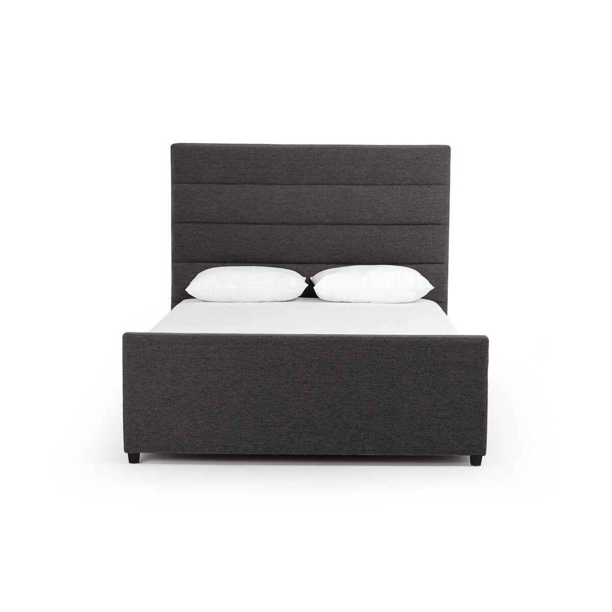 Dark gray upholstered bed with white bedding on a white background