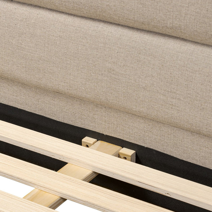 Close-up of a wooden frame with fabric covering, showing joints and construction details.