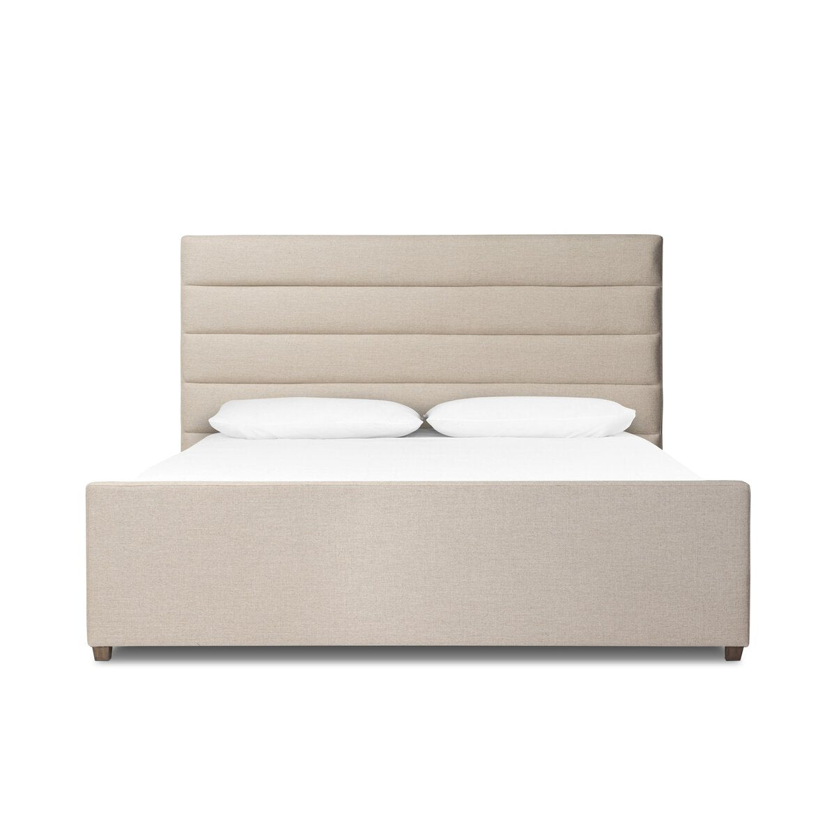 Beige upholstered bed with white pillows on a white background