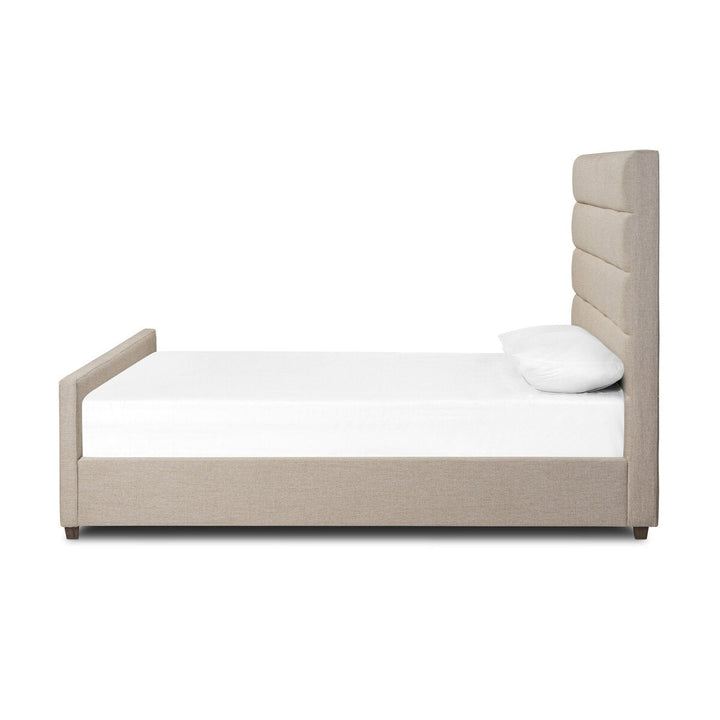 Beige upholstered bed with white mattress and pillow on a white background