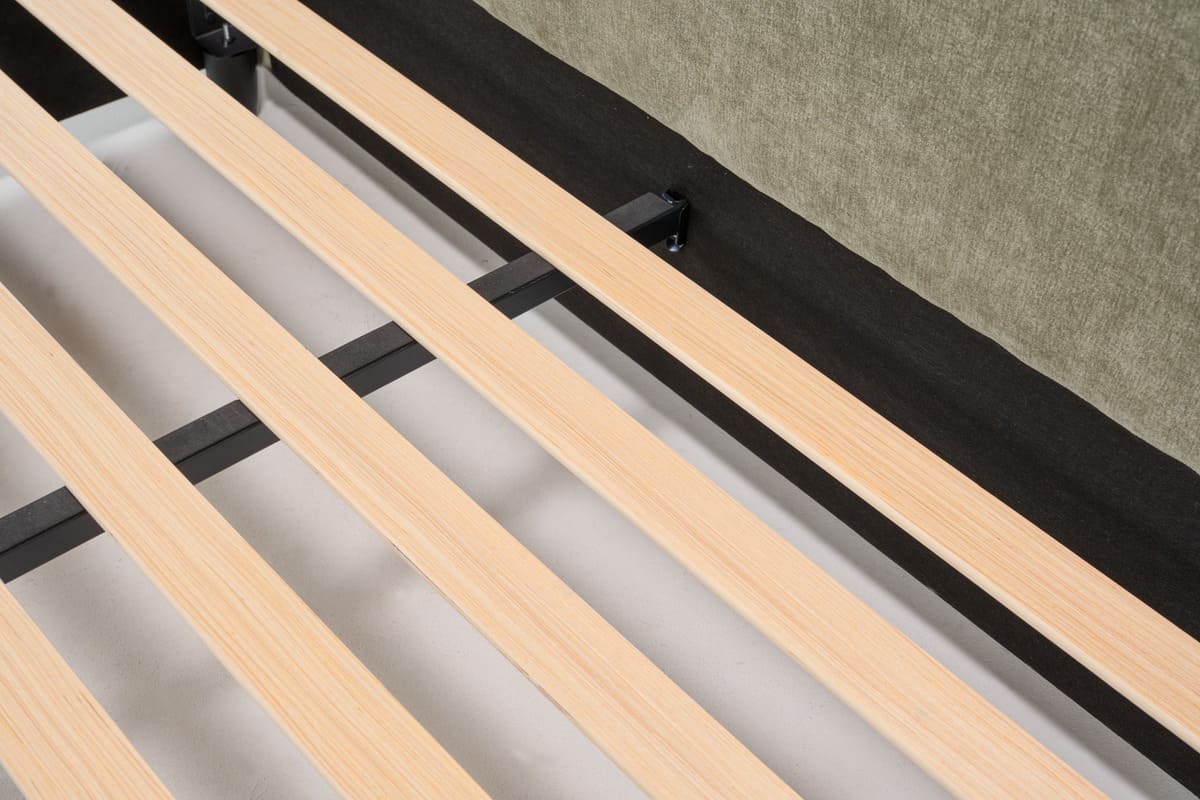 Wooden slats of a bed frame on a neutral background