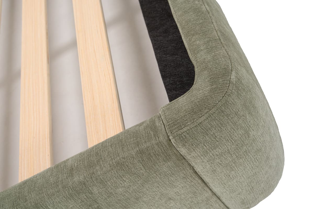 Green fabric with wooden sticks on a neutral background
