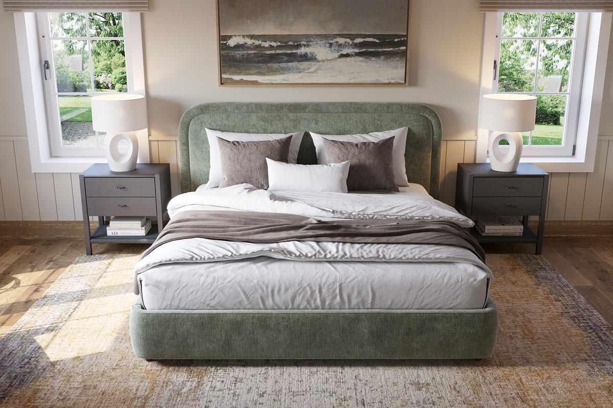 Bedroom with a green upholstered bed, two nightstands with lamps, and a large window.