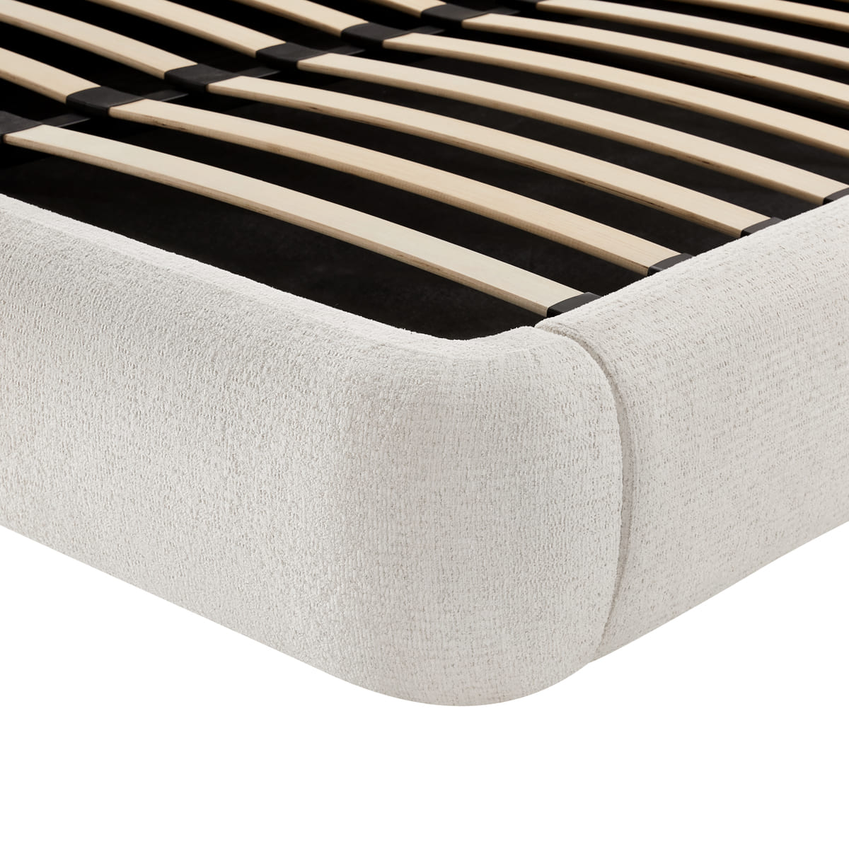 Close-up of a bed with wooden slats and a light gray mattress on a white background