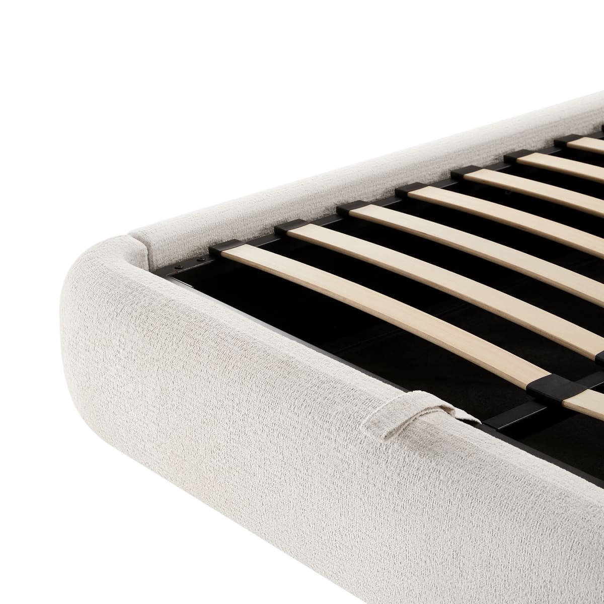Close-up of a bed with wooden slats and a white upholstered headboard on a white background