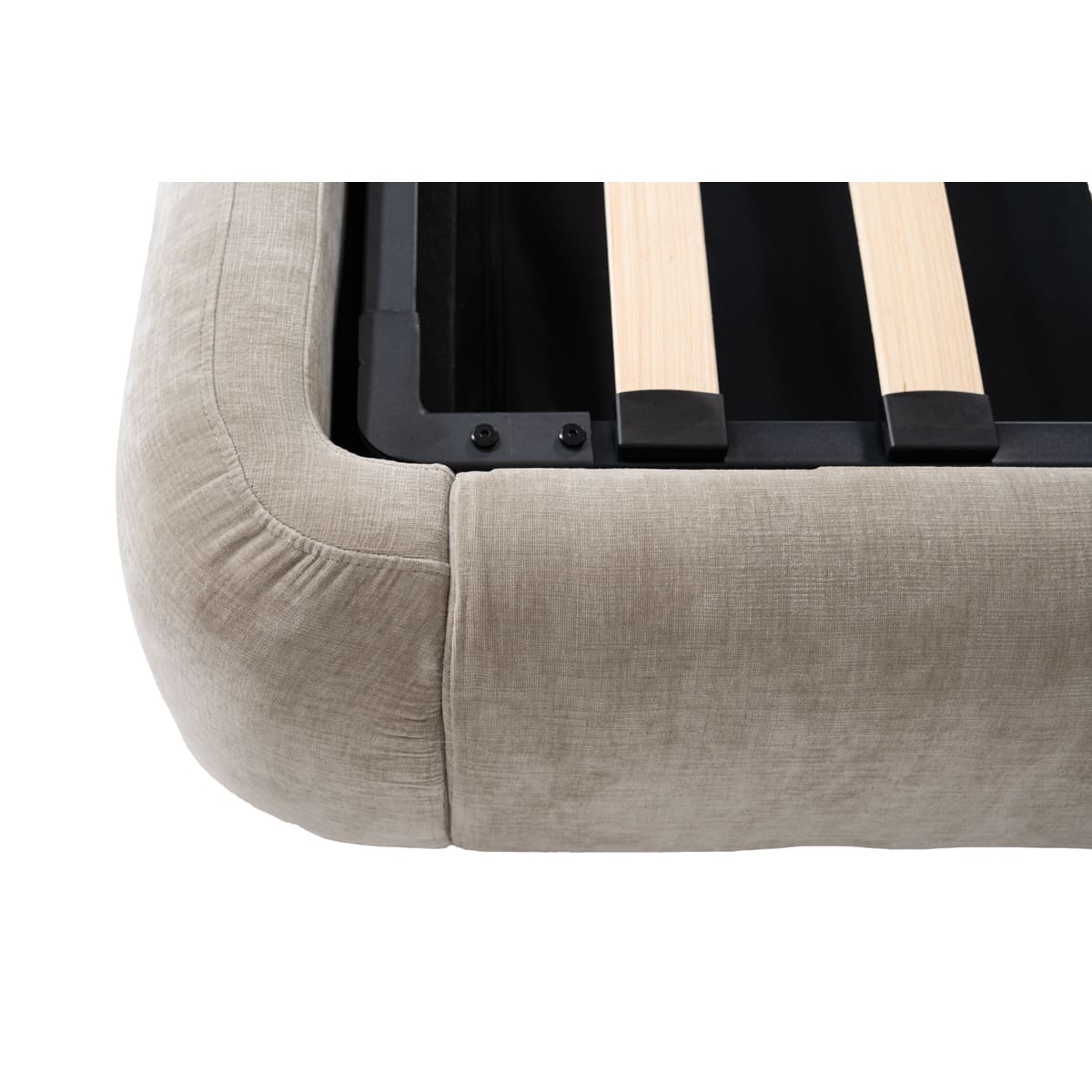 Close-up of a beige fabric surface with wooden legs and black metal brackets.