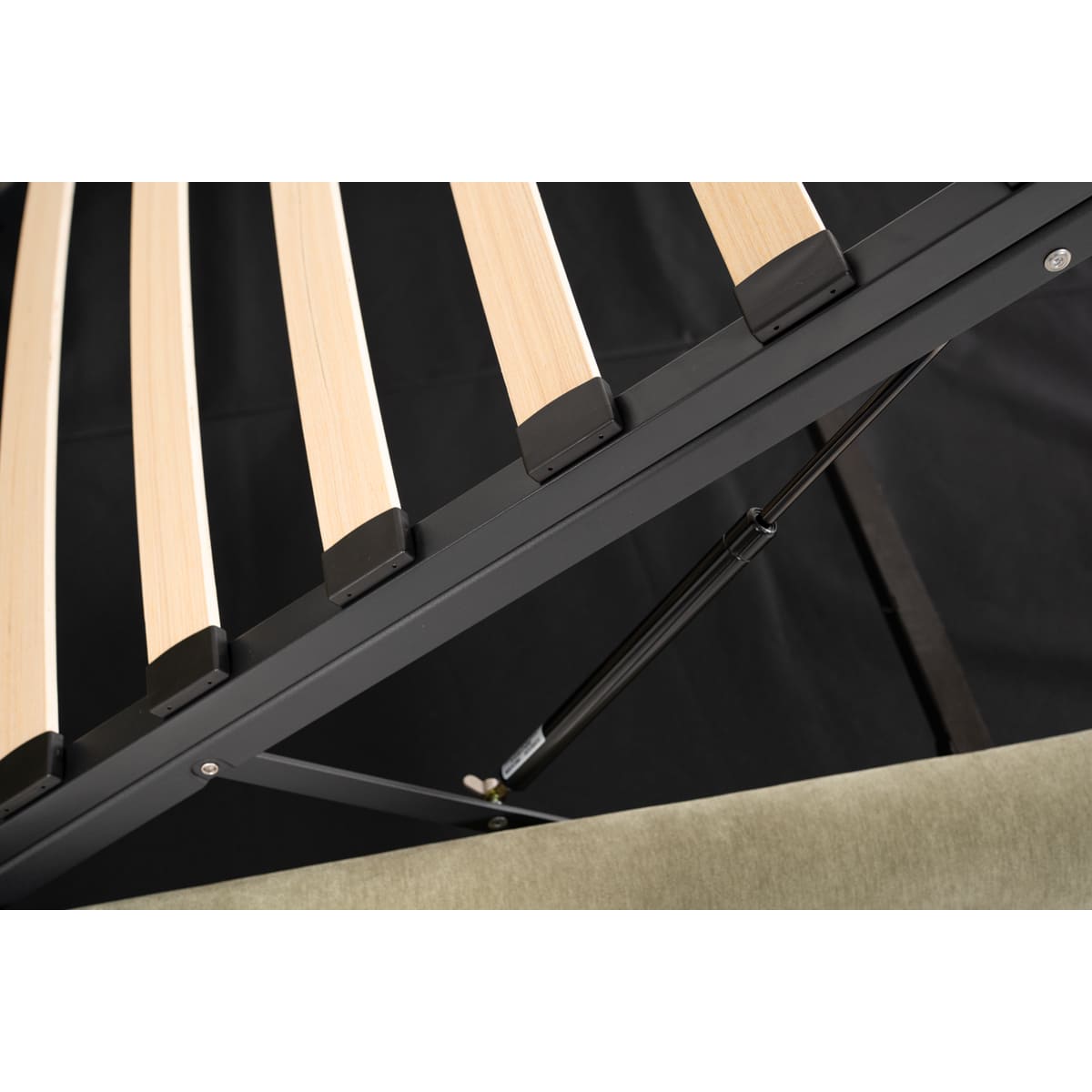 Close-up of a black metal bed frame with wooden slats on a white background