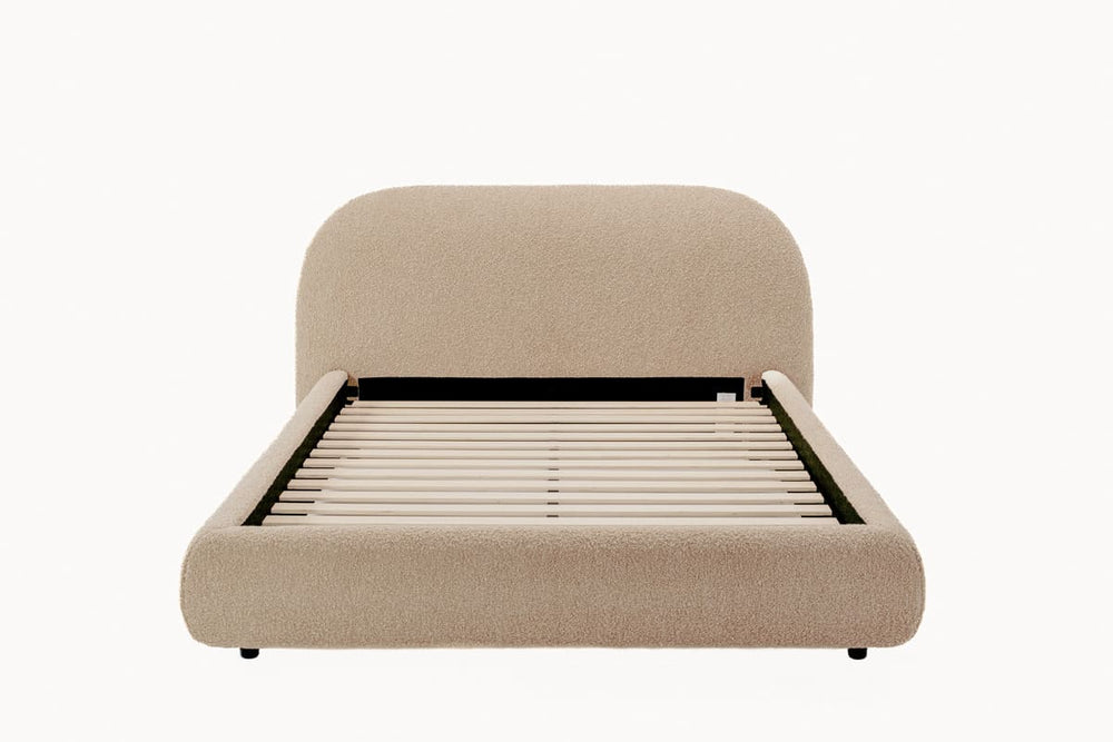 Beige upholstered bed frame on a white background