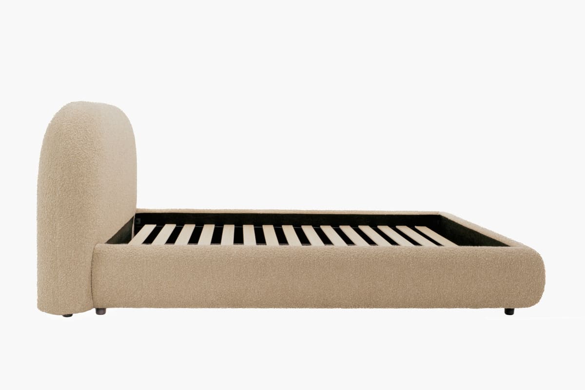 Beige upholstered bed frame on a white background