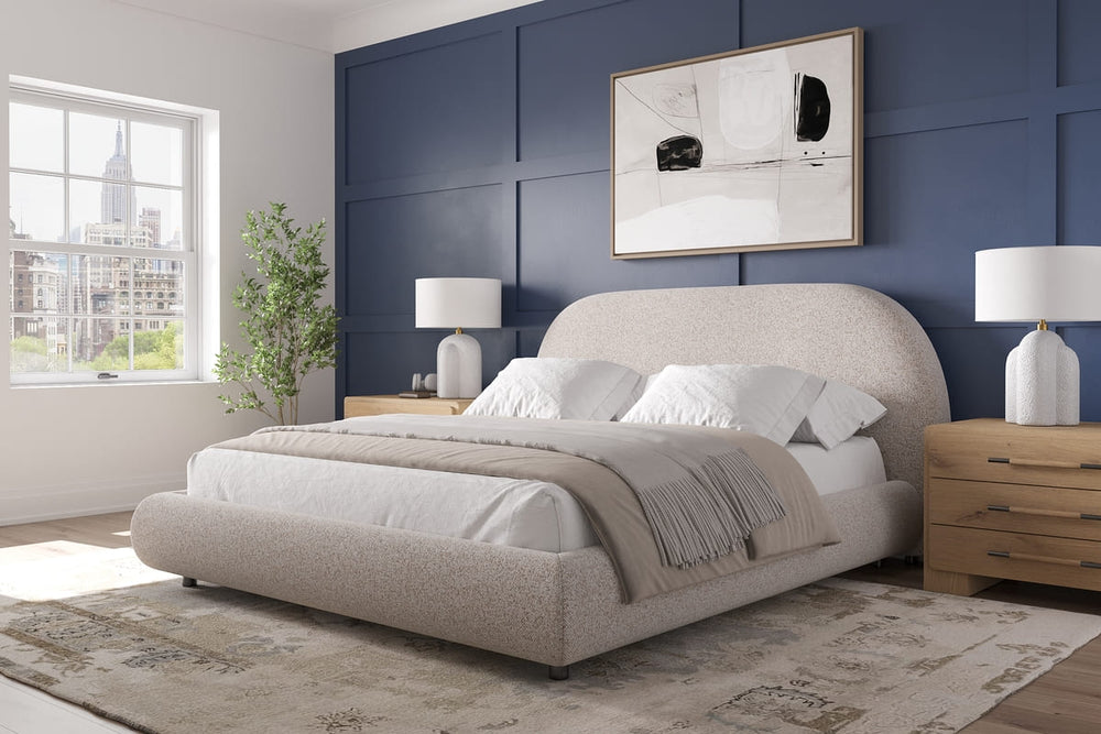 Modern bedroom with a large bed, nightstands, and wall art.