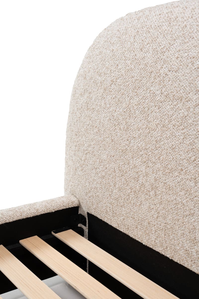 Close-up of a textured headboard with wooden slats on a white background