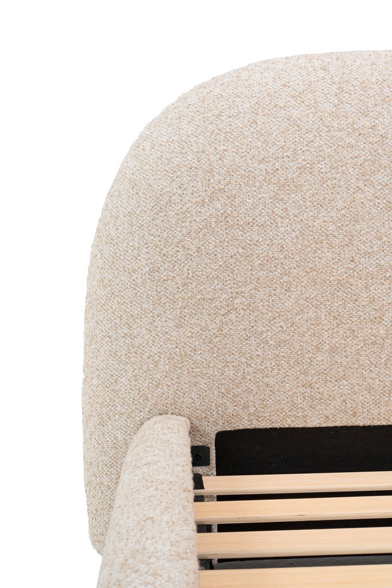 Close-up of a textured beige chair with wooden armrests on a white background