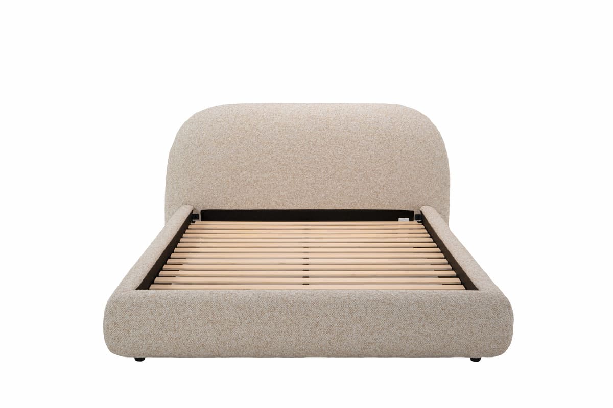 Beige upholstered bed with wooden slats on a white background