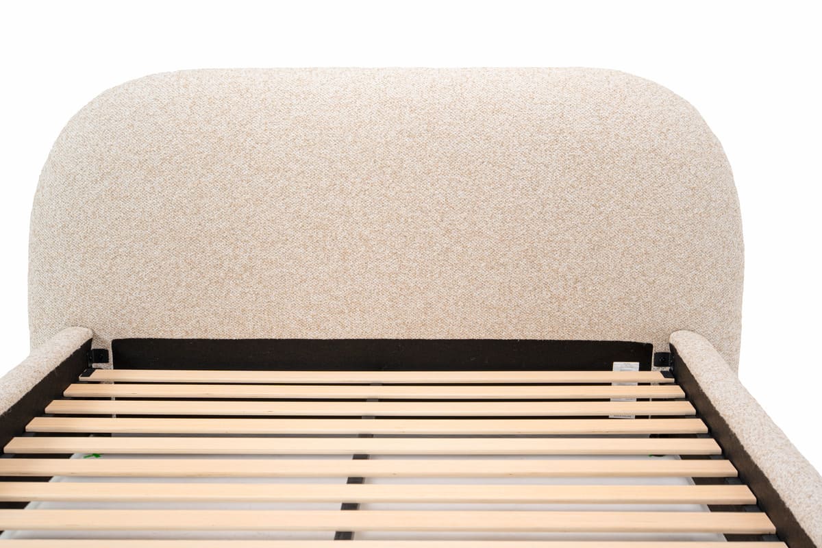 Beige upholstered bed frame with wooden slats on a white background