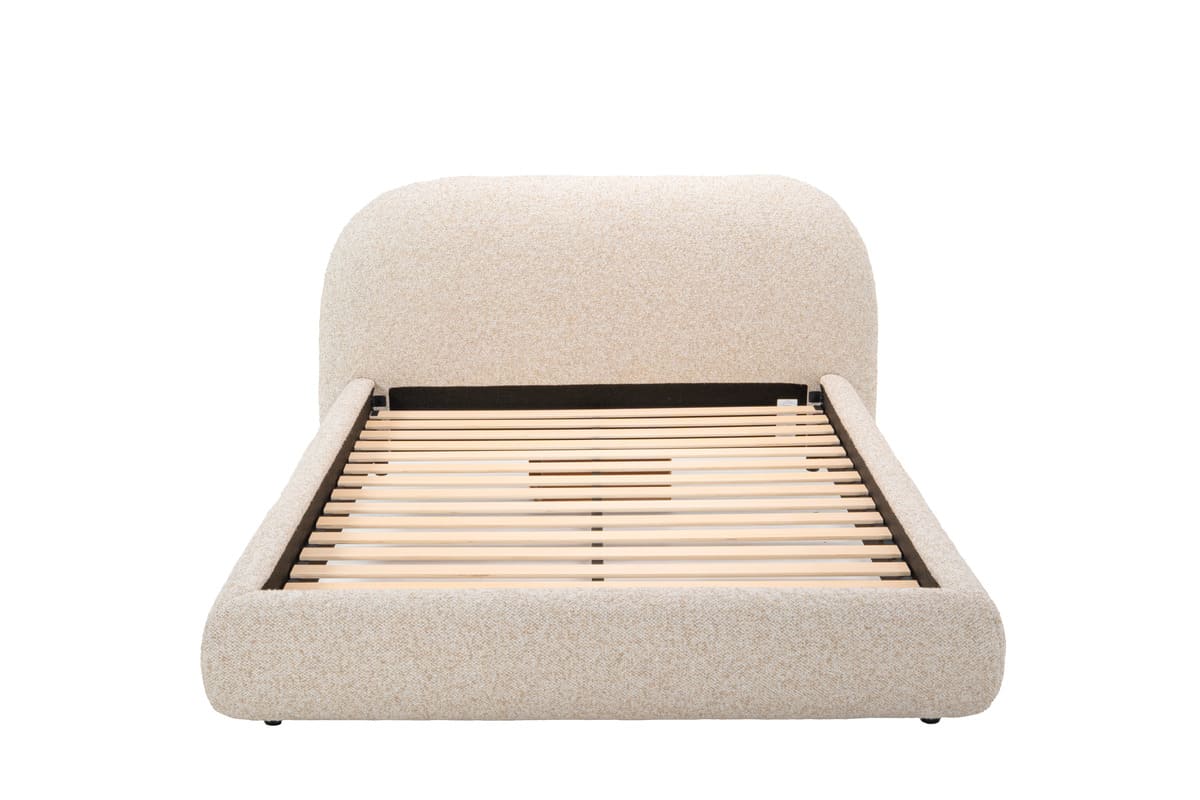 Beige upholstered bed with wooden slats on a white background