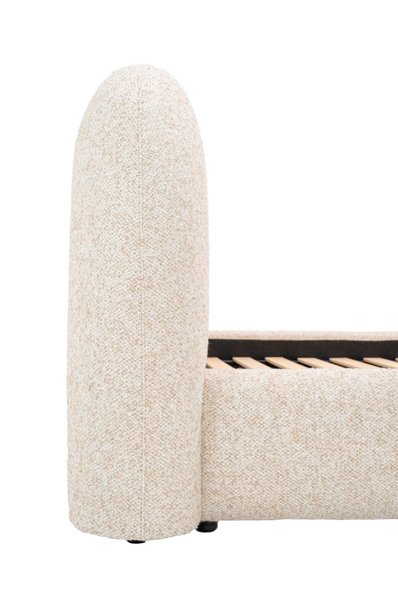 Beige upholstered bed frame with a wooden slat base on a white background
