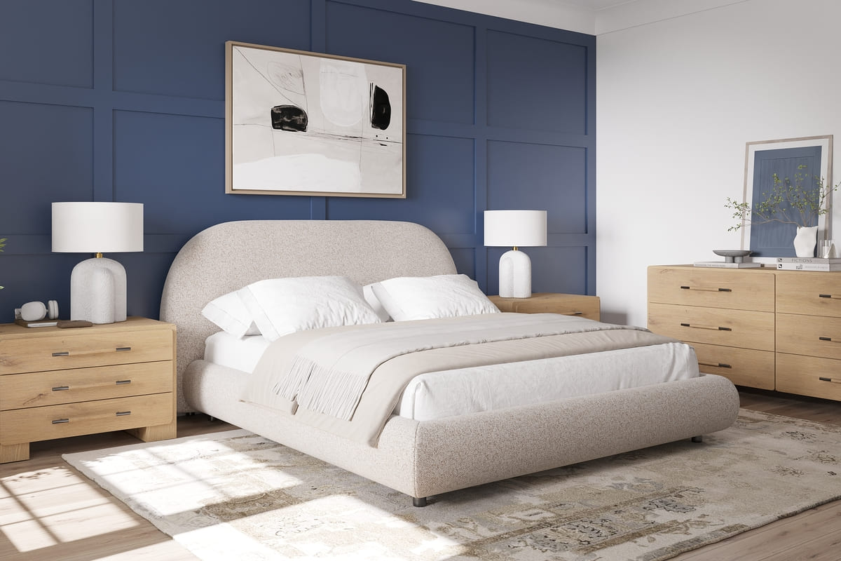 Modern bedroom with a beige upholstered bed, wooden nightstands, and a blue paneled wall.