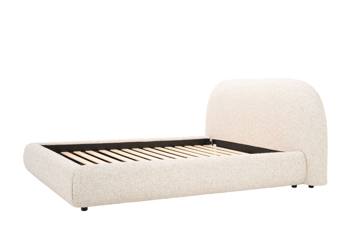 Beige upholstered bed with wooden slats on a white background