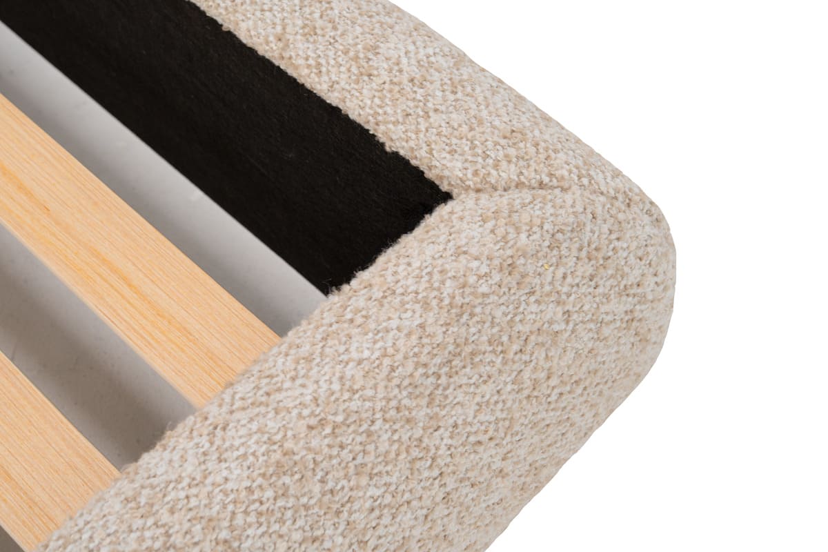 Close-up of a textured object with wooden and black elements on a white background