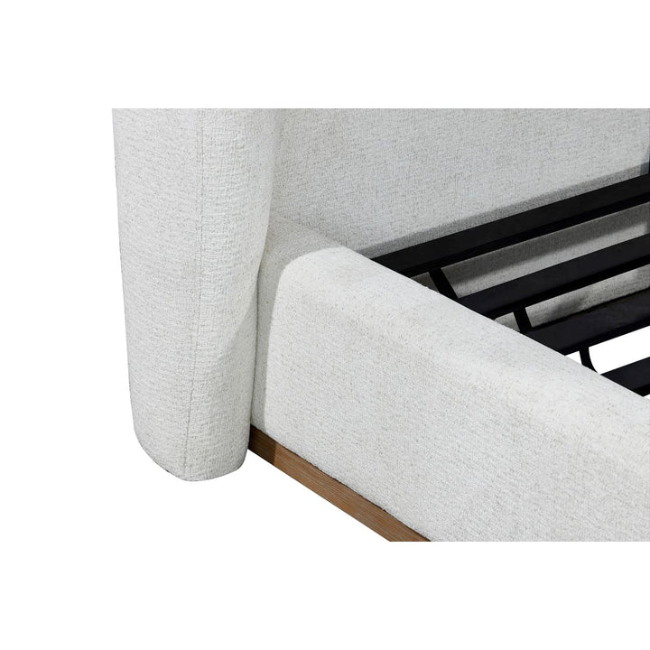 Close-up of a gray upholstered chair with wooden legs on a white background